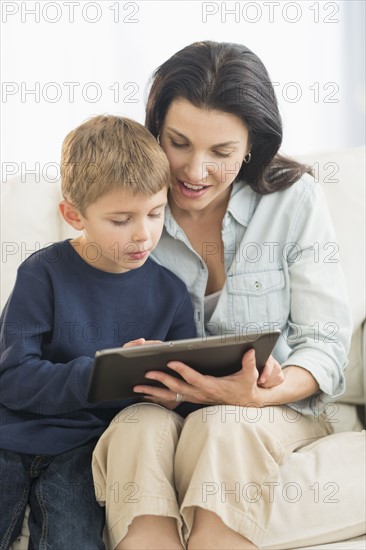 Mother and son (6-7) with tablet pc.