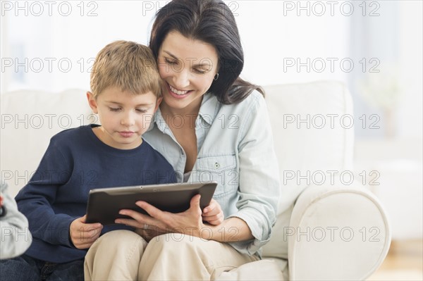 Mother and son (6-7) with tablet pc.