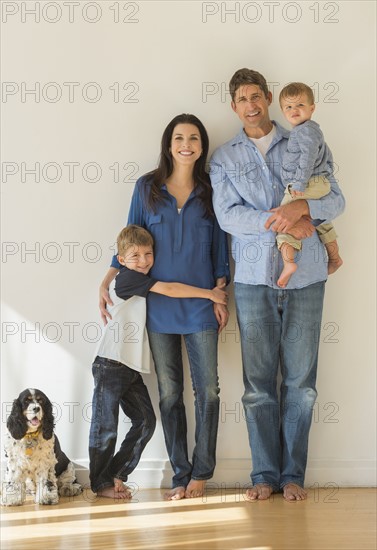 Portrait of parents with two sons (12-17 months, 6-7) and dog.