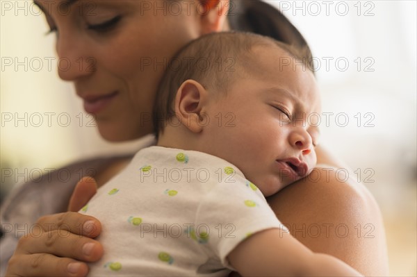 Mother holding baby (2-5 months).