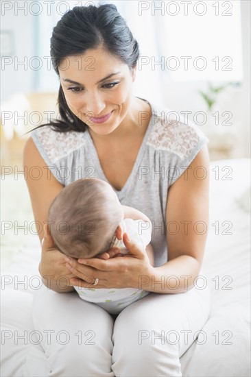 Mother playing with baby (2-5 months).