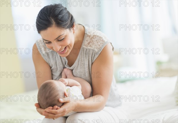Mother playing with baby (2-5 months).