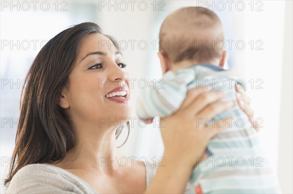 Mother playing with baby (2-5 months).