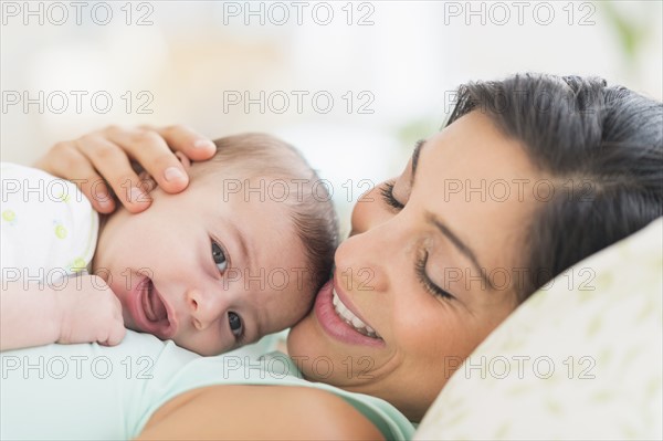 Mother playing with baby (2-5 months).