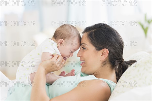 Mother playing with baby (2-5 months).