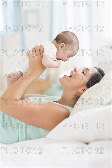 Mother playing with baby (2-5 months).