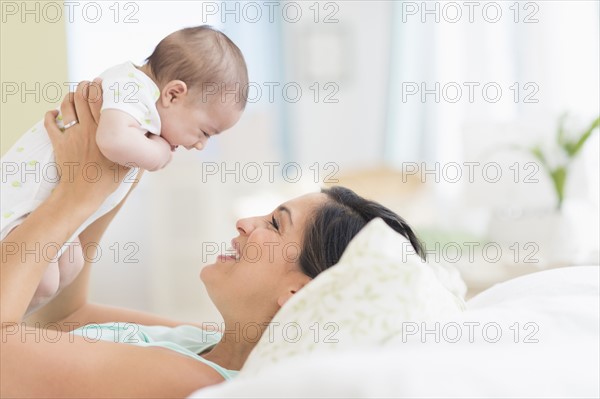 Mother playing with baby (2-5 months).