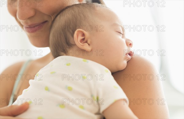 Mother holding baby boy (2-5 months).