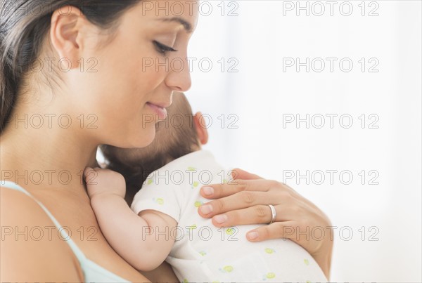 Mother holding baby boy (2-5 months).