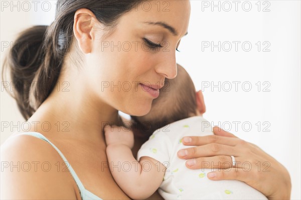 Mother holding baby boy (2-5 months).