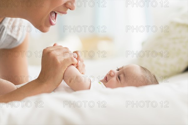 Mother playing with baby boy (2-5 months).