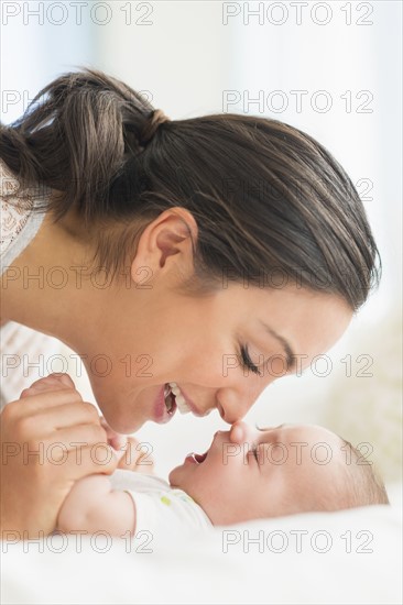 Mother playing with baby boy (2-5 months).