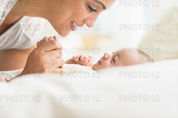 Mother playing with baby boy (2-5 months).