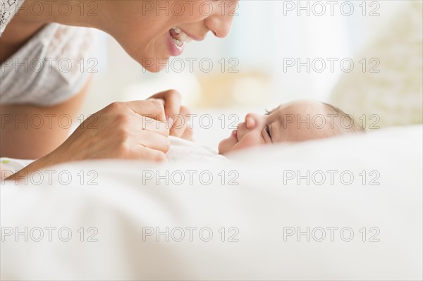 Mother playing with baby boy (2-5 months).