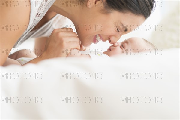 Mother playing with baby boy (2-5 months).