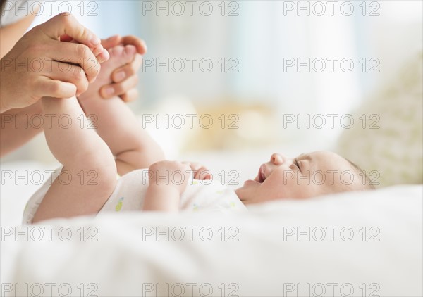 Mother playing with baby boy (2-5 months).