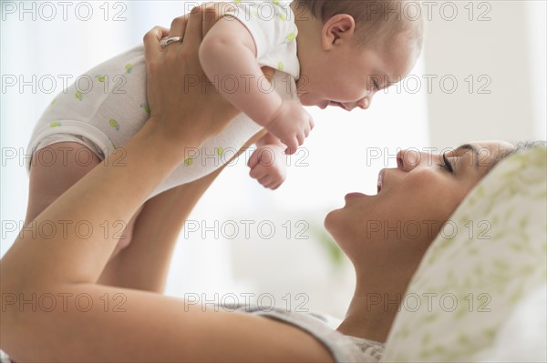 Mother playing with baby boy (2-5 months).