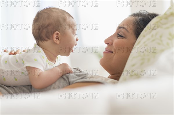 Mother playing with baby boy (2-5 months).