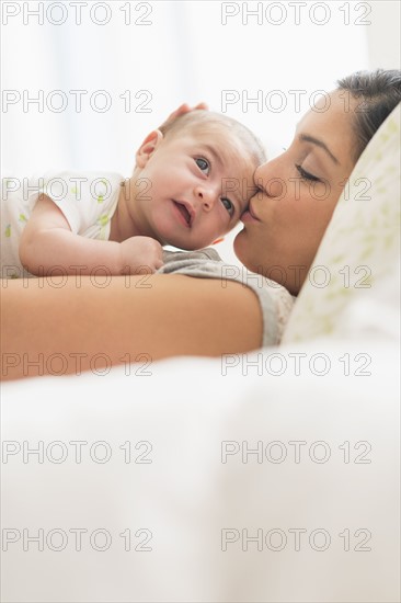 Mother kissing baby boy (2-5 months).