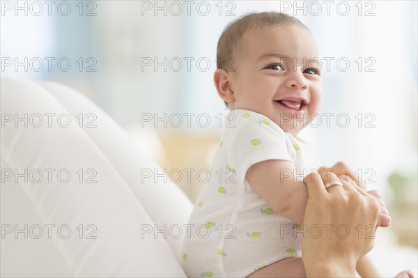 Baby boy (2-5 months) smiling.