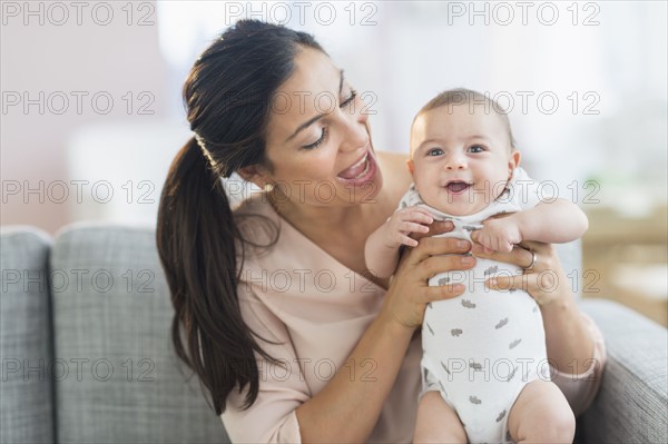 Mother holding baby boy (2-5 months).