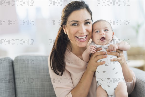 Mother holding baby boy (2-5 months).