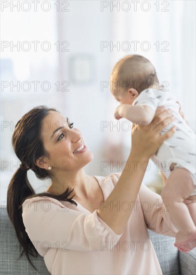 Mother holding baby boy (2-5 months).