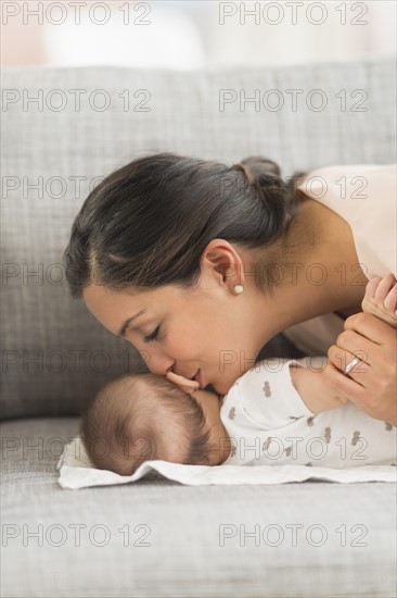 Mother kissing baby boy (2-5 months).