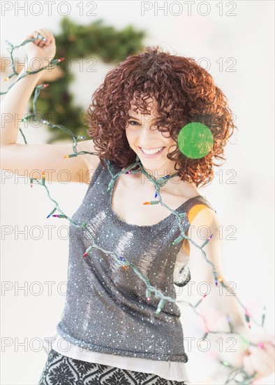 Woman holding christmas lights.