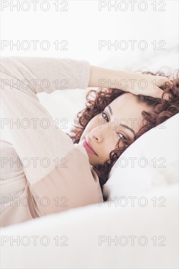 Beautiful woman lying in bed.