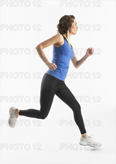 Studio shot of mature woman jogging.