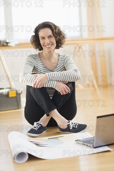 Woman sitting on floor.