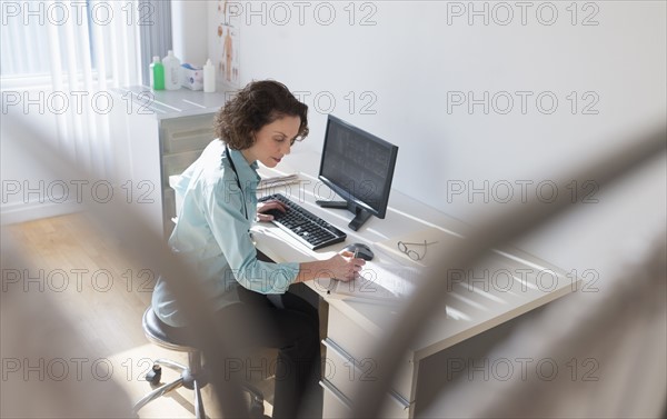 Female doctor working on computer.