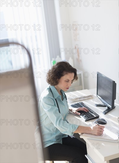 Female doctor doing notes.