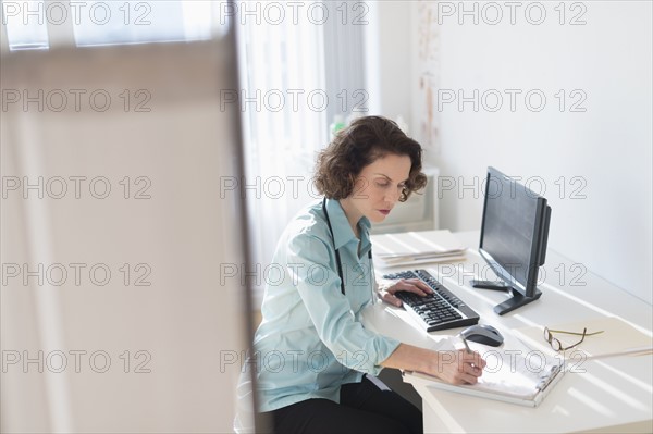 Female doctor doing notes.
