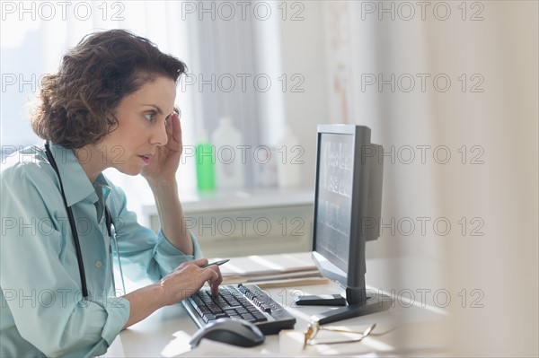 Female doctor working on computer.