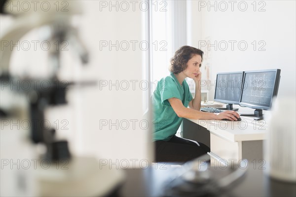 Female technician working on computer.