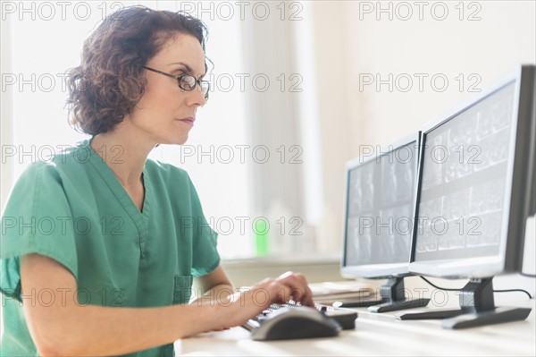 Female technician working on computer.
