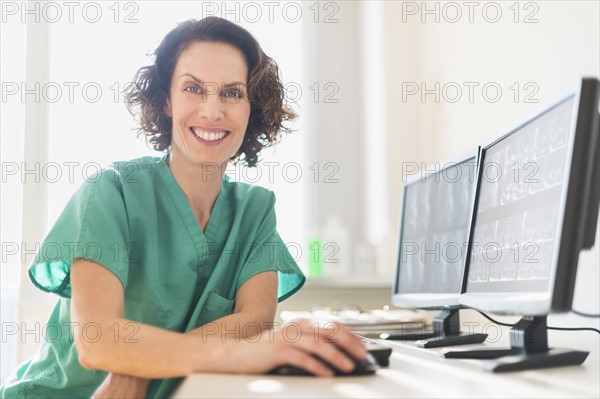 Female technician working on computer.