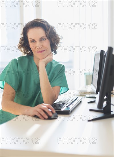 Female technician working on computer.