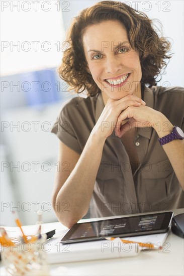 Portrait of business woman sitting at desk.