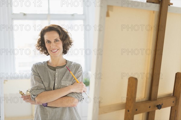 Portrait of female painter in studio.