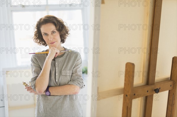 Portrait of female painter in studio.