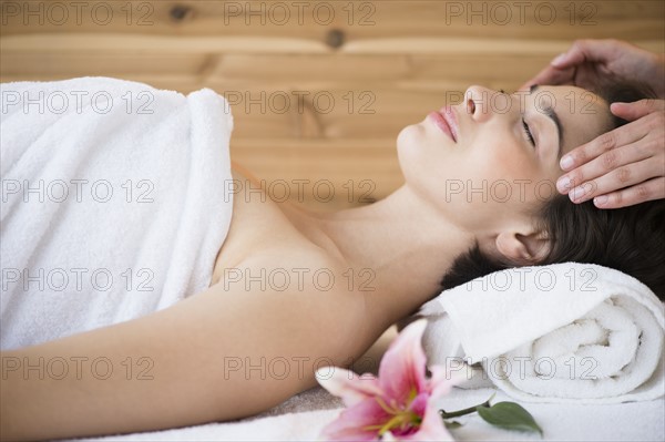 Woman receiving massage in spa.
Photo : Jamie Grill