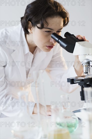 Scientist looking through microscope.
Photo : Jamie Grill