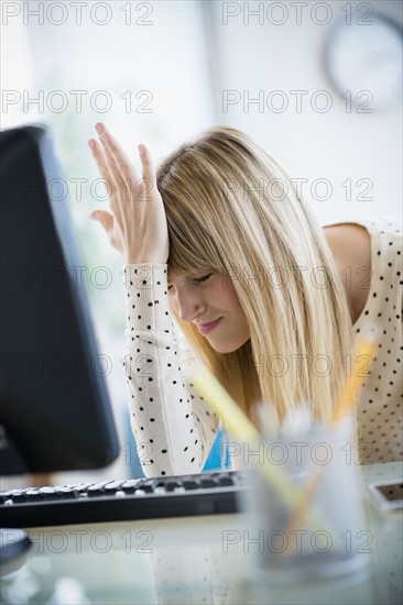 Woman suffering from headache in office.
Photo : Jamie Grill