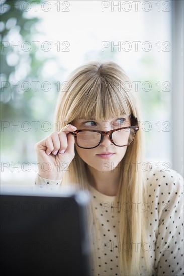 Woman looking above glasses.
Photo : Jamie Grill