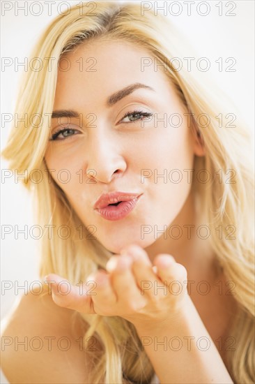 Portrait of teenage girl (16-17) blowing kiss.
Photo : Daniel Grill