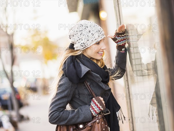 Portrait of blond woman looking at window display. USA, New York City, Brooklyn, Williamsburg.
Photo : Daniel Grill
