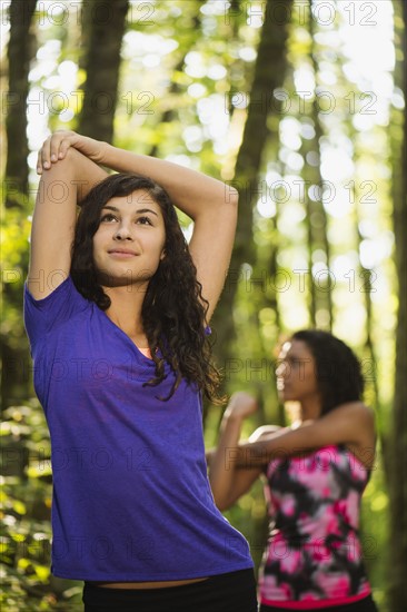 Two young women stretching. USA, Oregon, Portland.